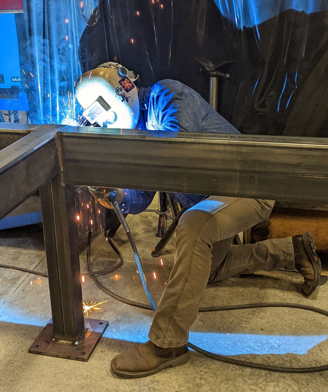 Jeff welding a steel frame in the shop
