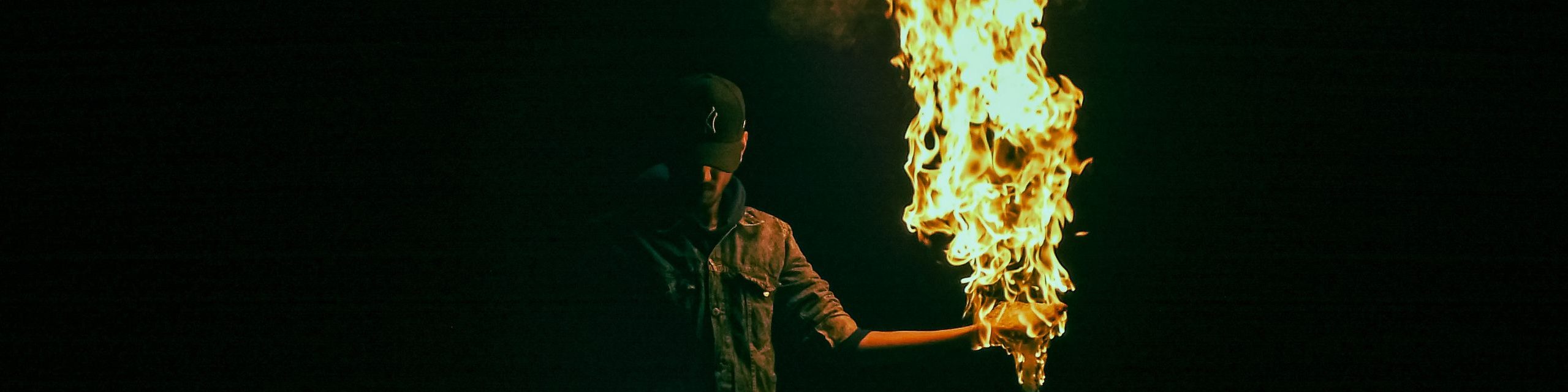 Captivating image of a fire performer in the dark, creating a mesmerizing display.